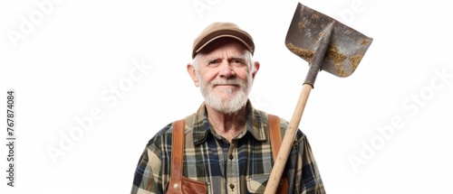 On a white background, a full length portrait of a happy mature farmer with a shovel is shown