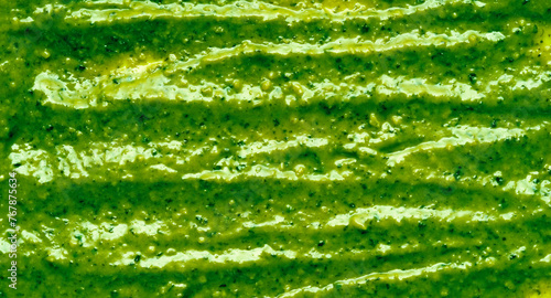 Pesto sauce close up green texture, background, top view