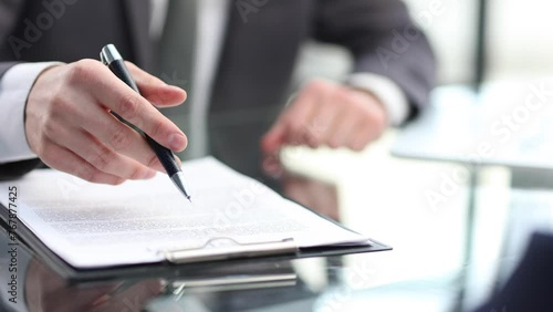 Businessmen in the office are talking and discussing documents in close-up