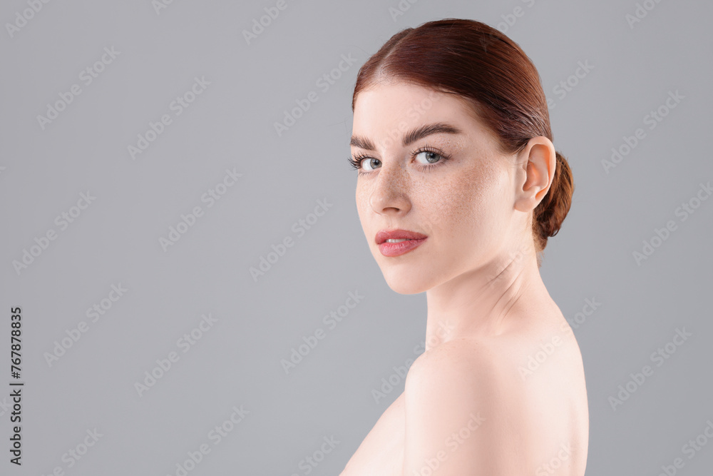 Portrait of beautiful woman on grey background. Space for text Portrait of beautiful woman on grey background. Space for text