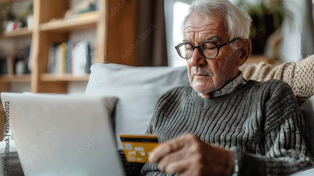 Senior man with credit card looking at laptop screen. Senior man with credit card looking at laptop screen.