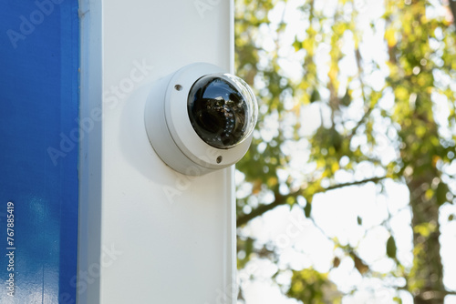 white CCTV camera camera on a street ATM. Providing security