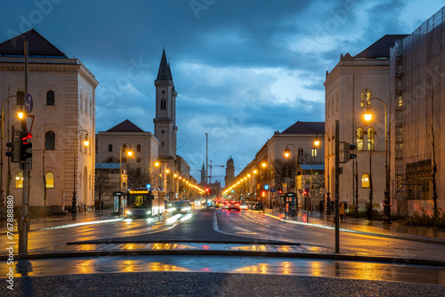 View from the Siegestor onto Ludwigstrasse with its famous buildings in Munich, Bavaria, Germany at blue hour. Motion blur of car headlights due to long exposure.