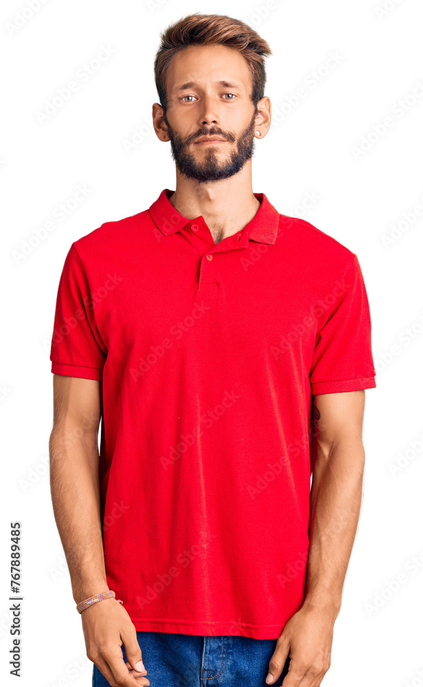 Handsome blond man with beard wearing casual clothes relaxed with serious expression on face. simple and natural looking at the camera. Handsome blond man with beard wearing casual clothes relaxed with serious expression on face. simple and natural looking at the camera.
