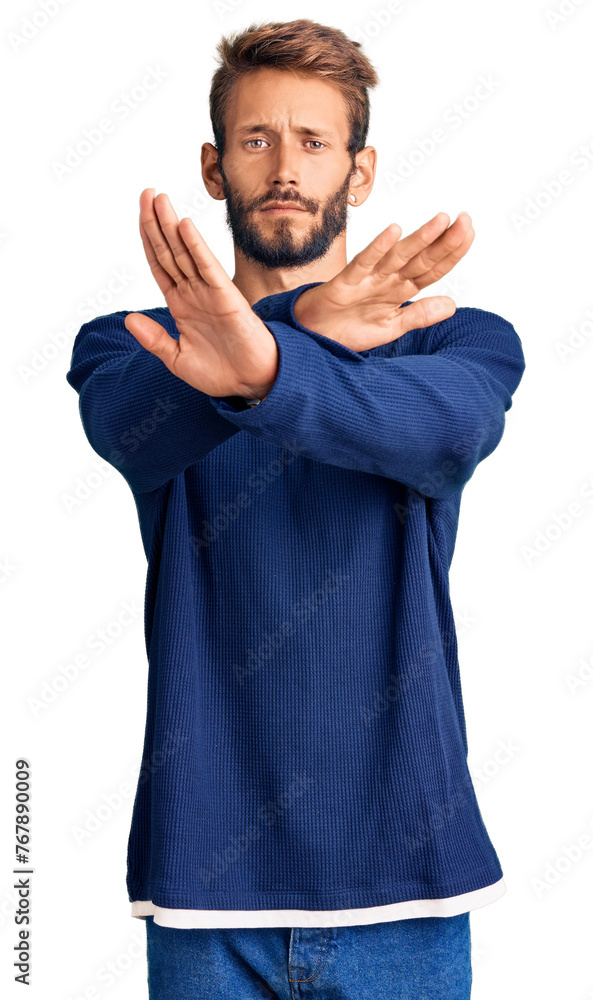 Handsome blond man with beard wearing casual sweater rejection expression crossing arms and palms doing negative sign, angry face Handsome blond man with beard wearing casual sweater rejection expression crossing arms and palms doing negative sign, angry face