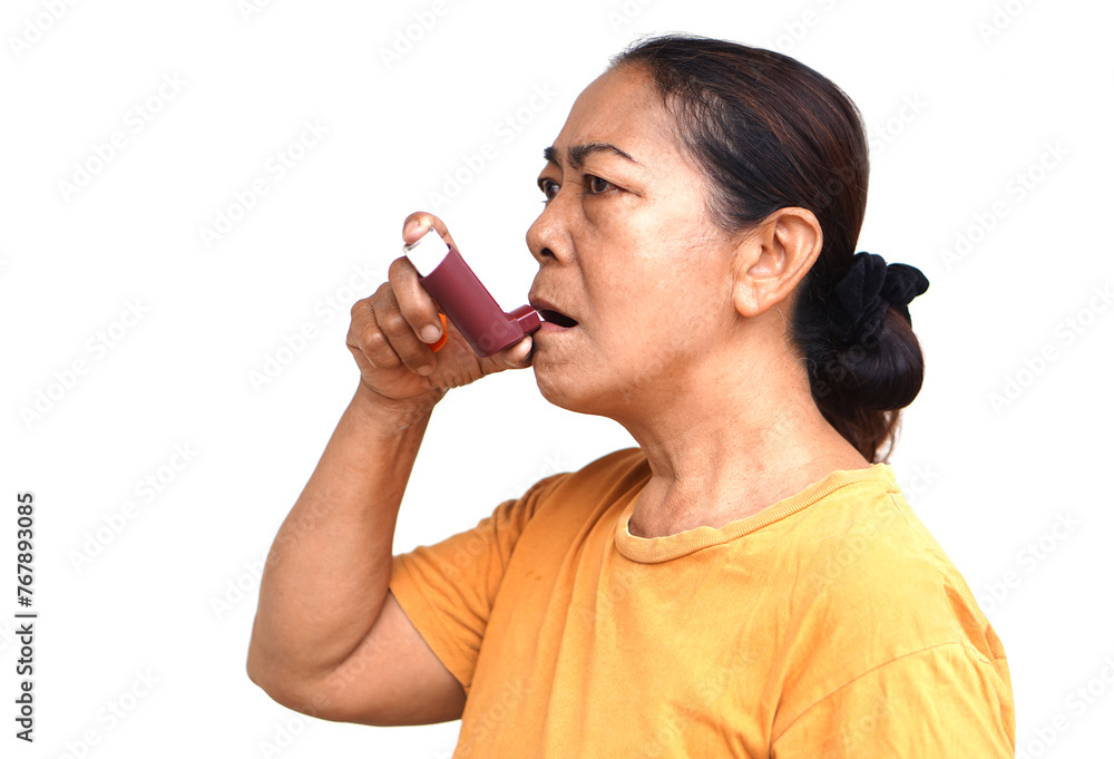 Female senior patient uses brown asthma inhaler for relief asthma. Concept, Health care at home. Pharmaceutical products for treatment symptoms of asthma or COPD. Use under prescription of doctor. Female senior patient uses brown asthma inhaler for relief asthma. Concept, Health care at home. Pharmaceutical products for treatment symptoms of asthma or COPD. Use under prescription of doctor.