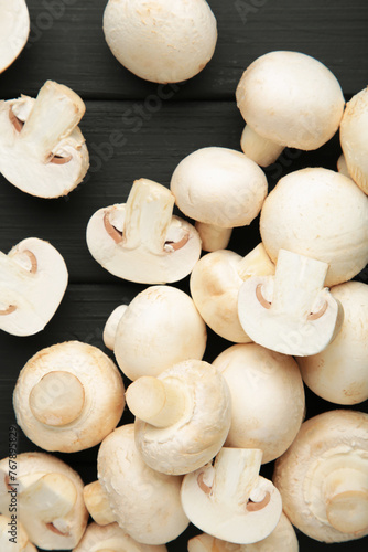 Fresh white mushrooms champignon on black background.