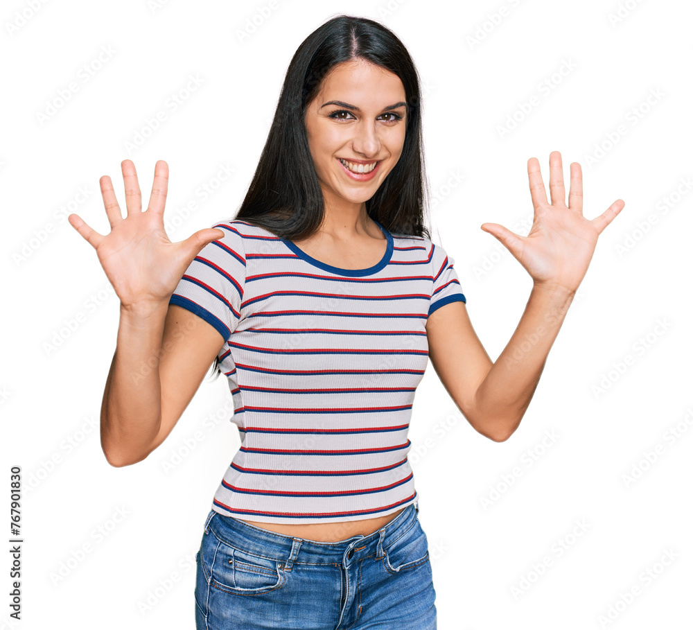 Young hispanic girl wearing casual striped t shirt showing and pointing up with fingers number ten while smiling confident and happy. Young hispanic girl wearing casual striped t shirt showing and pointing up with fingers number ten while smiling confident and happy.