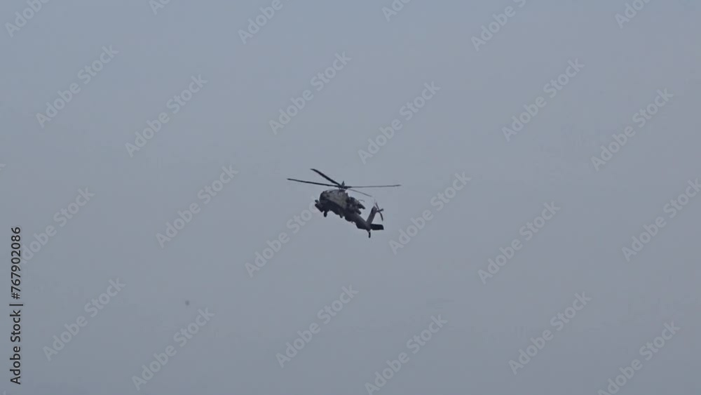 Military Attack Helicopter flying in the distance Military Attack Helicopter flying in the distance