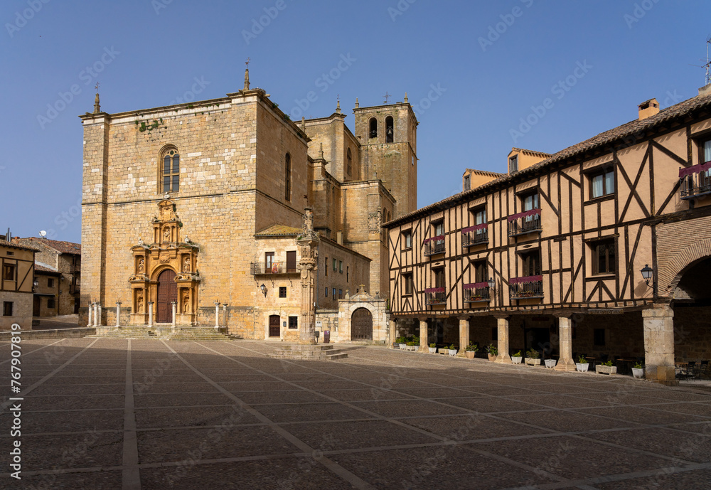 Mayor square and Santa Ana church in the medieval village of Peñaranda de Duero at sunset, Burgos, Spain.