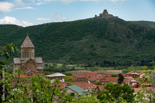 The Svetitskhoveli Cathedral, an Orthodox Christian cathedral and Jvari Church in the distance, in the historic town of Mtskheta, Georgia. photo