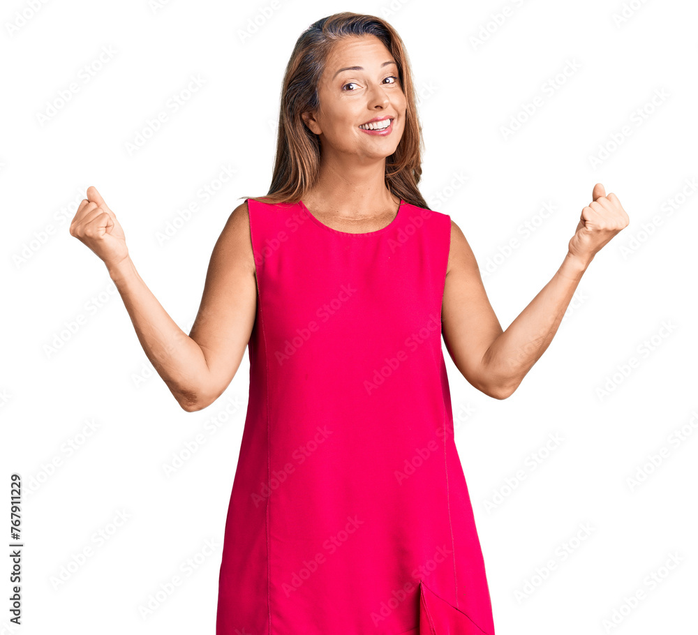 Middle age hispanic woman wearing casual clothes screaming proud, celebrating victory and success very excited with raised arms Middle age hispanic woman wearing casual clothes screaming proud, celebrating victory and success very excited with raised arms