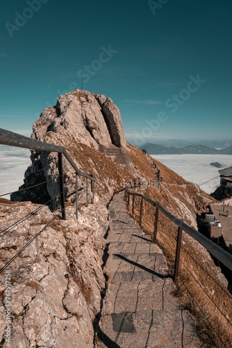 rocky stairs in the mountains above clouds of snow