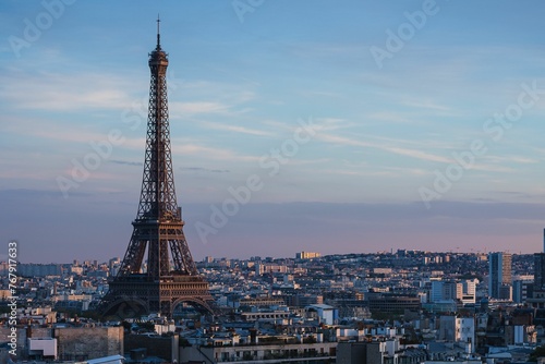 Stunning sunset view of the Eiffel Tower and nearby buildings in Paris, France © Wirestock