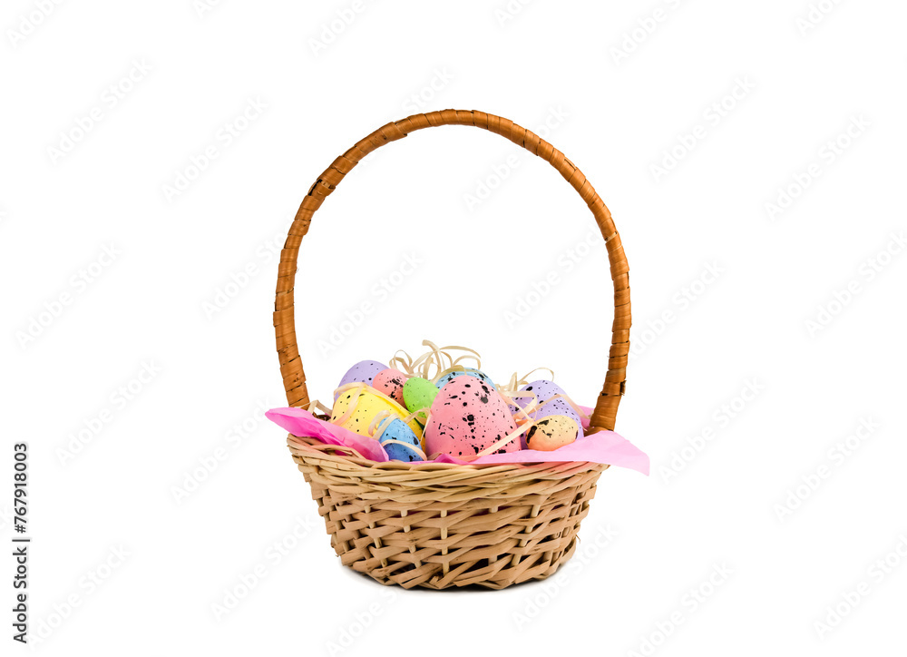 Decorative colorful Easter eggs in a wicker basket isolated on white background. Easter decor.