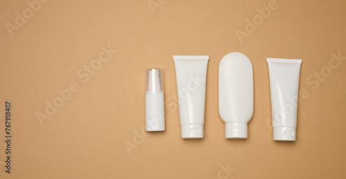 Wallpaper Mural White plastic tubes, jars, and containers for cosmetic products on a brown background Torontodigital.ca
