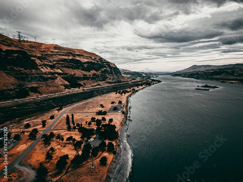 Aerial view of a bridge spanning across a John Day Dam on a sunny day photo