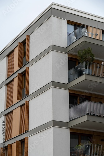 Exterior of a modern apartment complex with small balconies