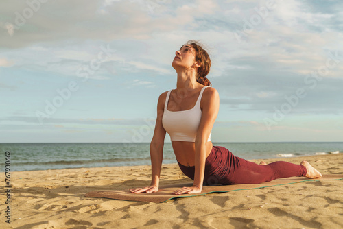Woman in yoga pose on beach alone - practice of serenity and mindfulness, harmonious connection with nature. Peaceful meditation and wellness lifestyle.