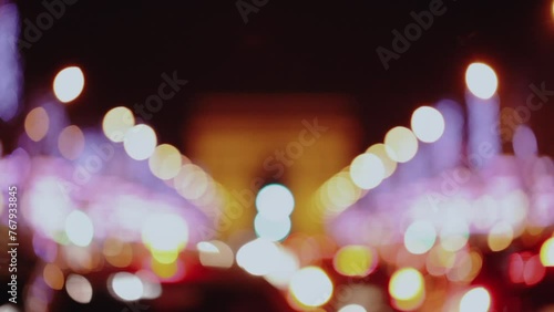 Champs-Elysees city street with defocused traffic lights at night in Paris