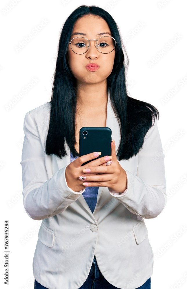 Beautiful hispanic woman with nose piercing using smartphone typing message puffing cheeks with funny face. mouth inflated with air, catching air. Beautiful hispanic woman with nose piercing using smartphone typing message puffing cheeks with funny face. mouth inflated with air, catching air.
