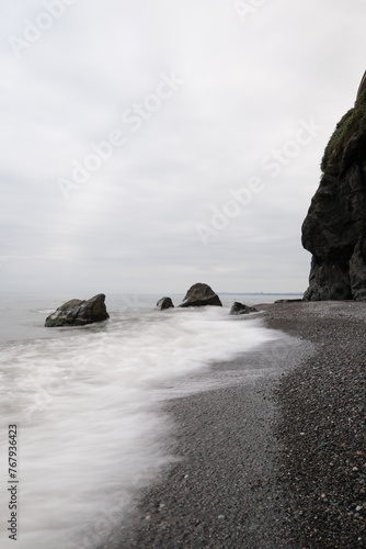 Water waves of the Black Sea crashing on rocks on the stony shore, coast - close up, nobody, no people. Nature, element, landscape