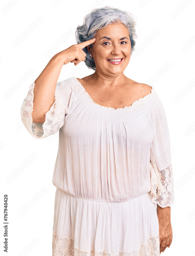 Senior woman with gray hair wearing bohemian style smiling pointing to head with one finger, great idea or thought, good memory Senior woman with gray hair wearing bohemian style smiling pointing to head with one finger, great idea or thought, good memory