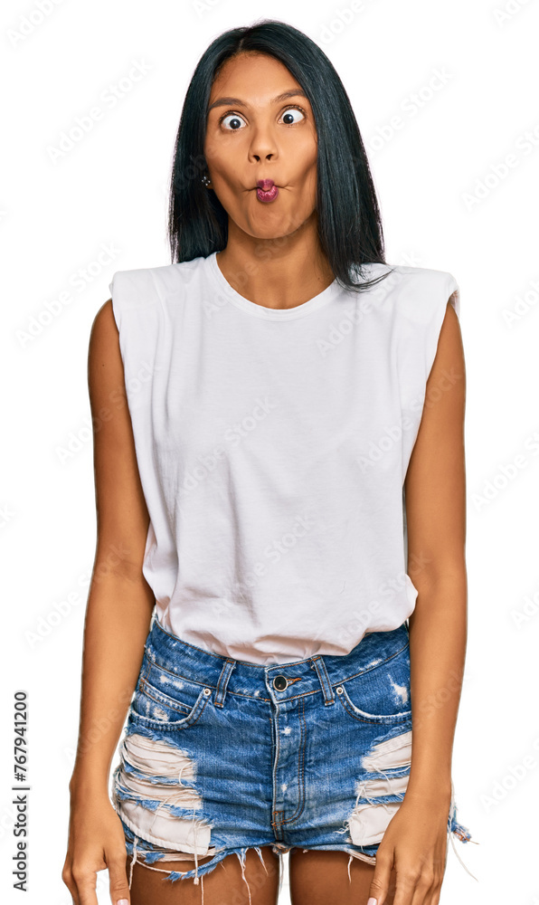 Young african american woman wearing casual clothes making fish face with lips, crazy and comical gesture. funny expression. Young african american woman wearing casual clothes making fish face with lips, crazy and comical gesture. funny expression.