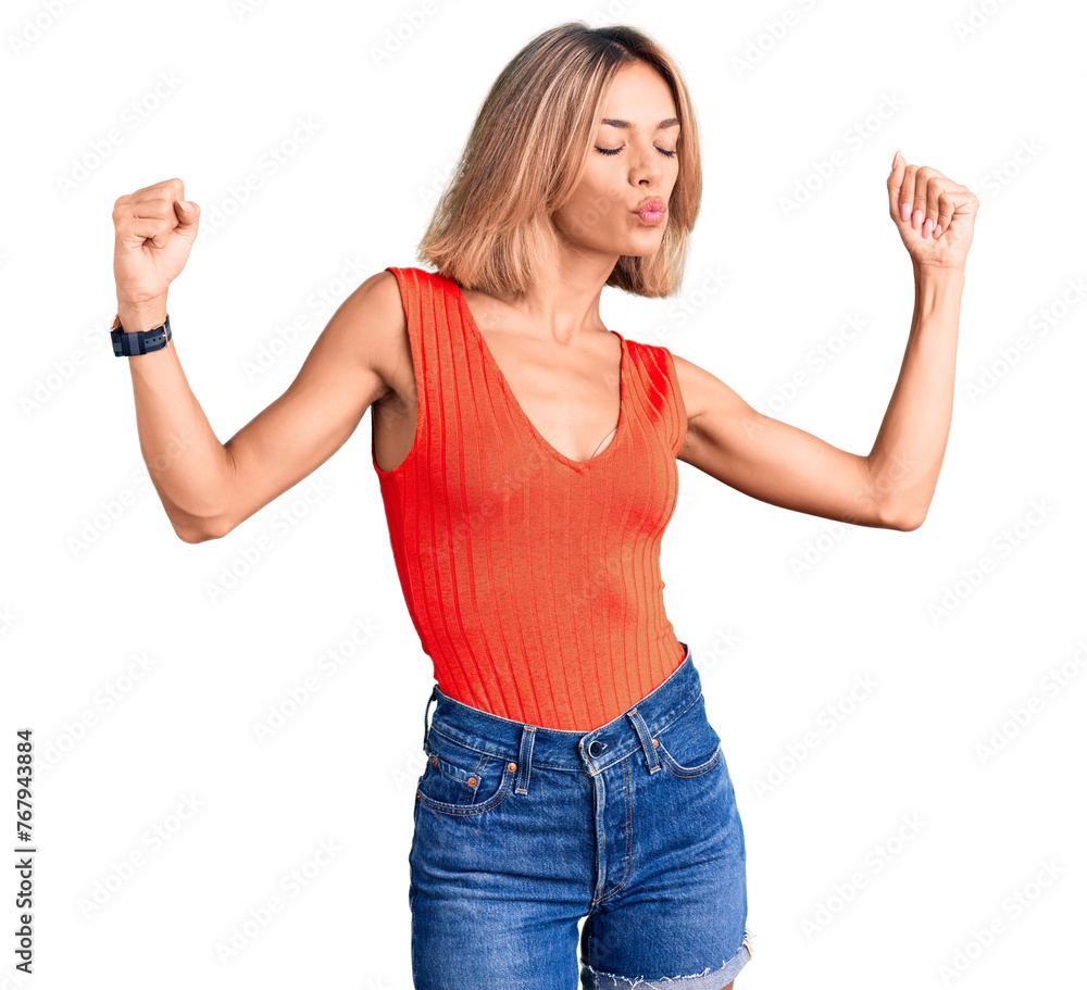 Beautiful caucasian woman wearing casual clothes showing arms muscles smiling proud. fitness concept. Beautiful caucasian woman wearing casual clothes showing arms muscles smiling proud. fitness concept.