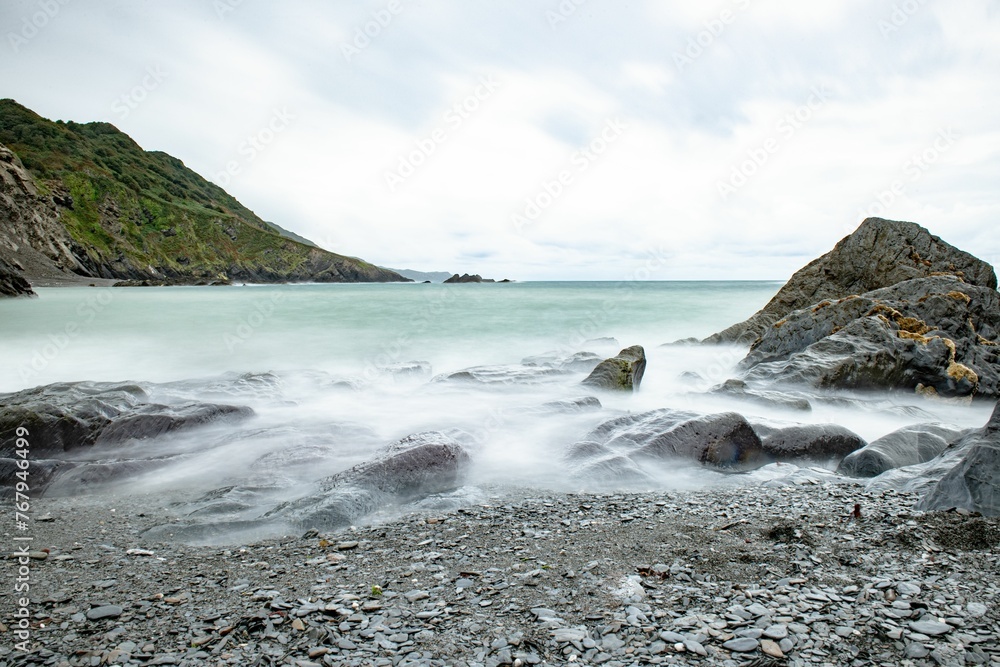 Scenic view of the rocky shoreline along Tunnels Beaches in Ilfracombe, England with a stunning view Scenic view of the rocky shoreline along Tunnels Beaches in Ilfracombe, England with a stunning view