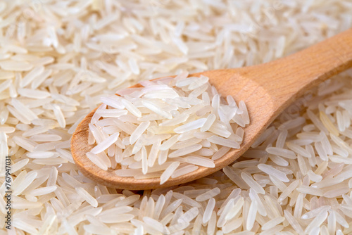Raw basmati rice in wooden spoon