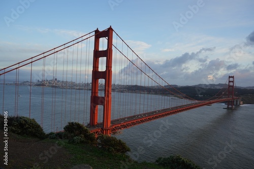 Aerial view of the Battery Spencer arch bridge spanning a wide body of water photo