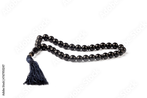 Black prayer beads with 33 knots made of stone on a matte surface on a white background (Turkish name; Tespih) photo