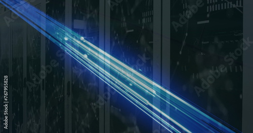 Image of glowing blue light trails and network of connections over computer server room