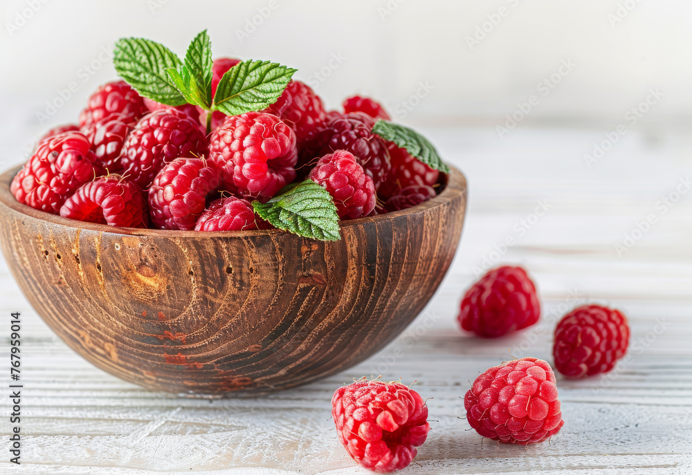 Fresh raspberries in wooden bowl on white wooden background Fresh raspberries in wooden bowl on white wooden background