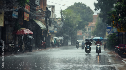 People with umbrellas on motorbikes in rainy street.