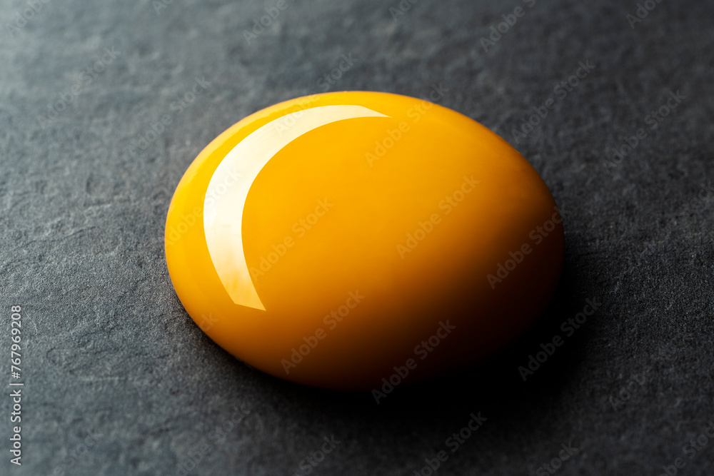Egg yolk on black background