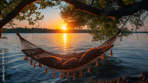 Hammock on the lake at sunset. Beautiful nature background. © D-stock photo