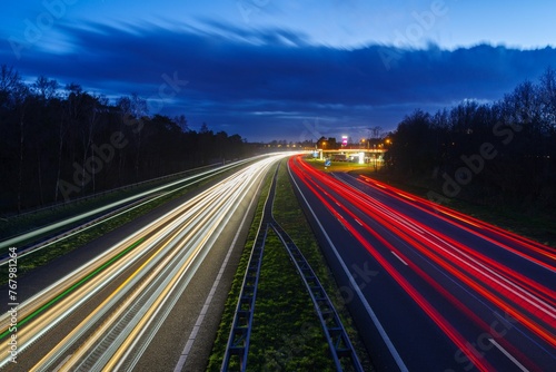 Long exposure to a busy road at night, illuminated by street lights