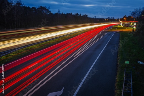 Two-lane road surrounded by street lights with long exposure at night