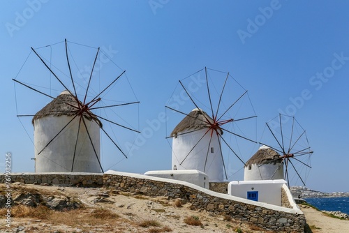 Windmills with wooden blades against the blue sky in Mykonos, Greece