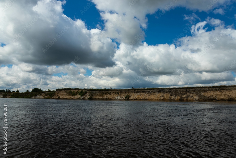 The steep sandy shore of the river. Large pine forest. Selective focus The steep sandy shore of the river. Large pine forest. Selective focus
