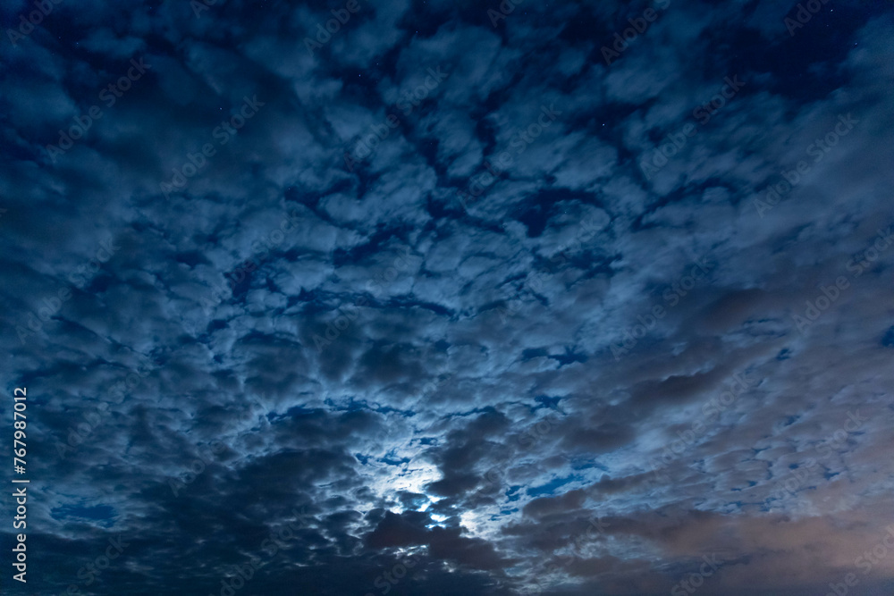Moon in the night sky among the clouds