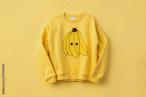 Yellow sweatshirt with banana print. Fashion clothes concept