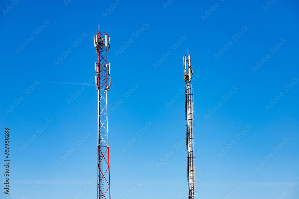 Cellular Base Station or Base Transceiver Station. Telecommunication tower. Wireless Communication Antenna Transmitter. 3G, 4G and 5G Cell Site with blue and cloudy sky. Cellular Base Station or Base Transceiver Station. Telecommunication tower. Wireless Communication Antenna Transmitter. 3G, 4G and 5G Cell Site with blue and cloudy sky.