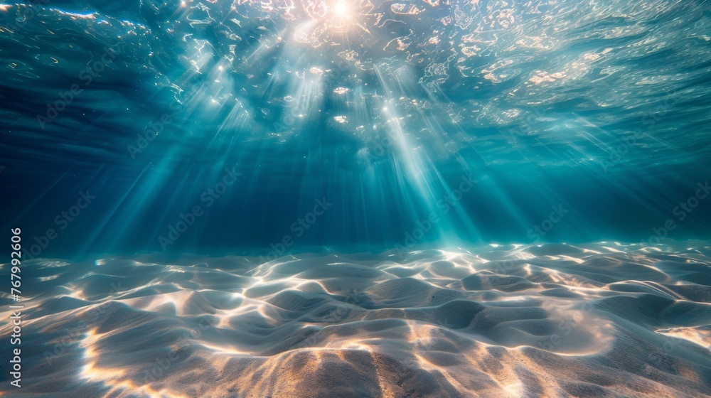 Underwater background featuring a deep blue sea with beautiful light rays piercing through the water Underwater background featuring a deep blue sea with beautiful light rays piercing through the water