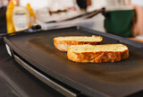 Slice of garlic bread on the hot pan.