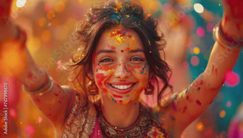 Happy Indian woman in traditional Indian dress dancing and celebrating the Holi festival