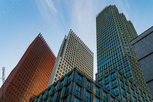 Vertical view of skyscrapers in The Haag central district, the Netherlands. Morning light, blue sky with thin clouds. Modern Colorful buildings.  