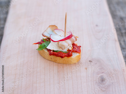 Finger food, canape with cheese salad and bacon.
